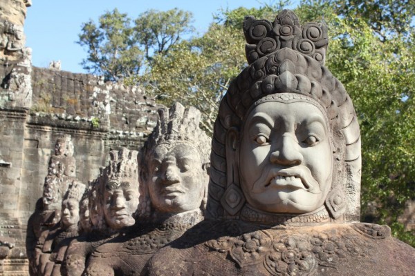 Stone warrior on a bridge leading into the 12th century city of Angkor Thom.